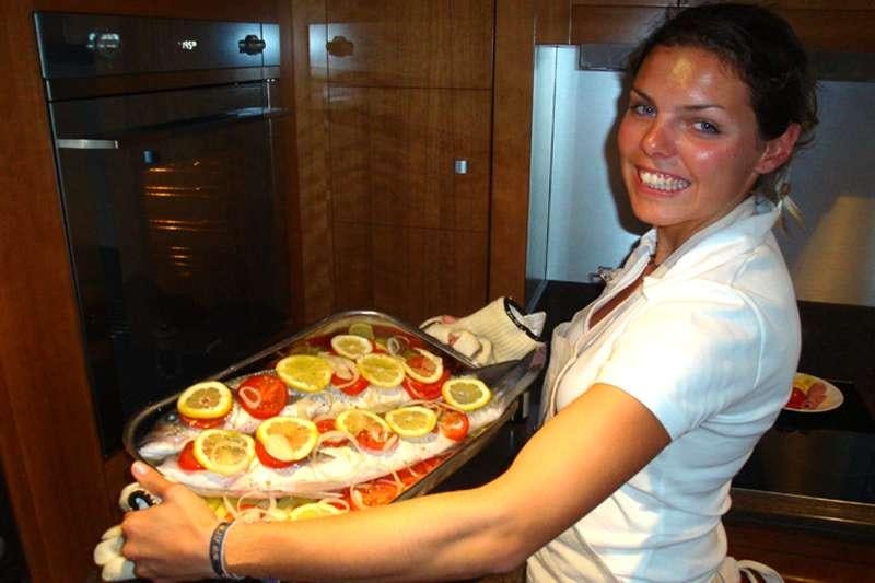 a person holding a pizza aboard MOBY DICK Yacht for Charter