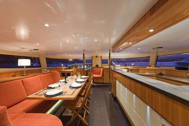 a room with a table and chairs aboard MOBY DICK Yacht for Charter