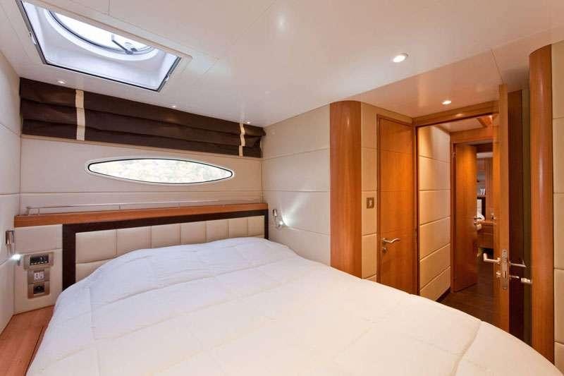 a bedroom with a bed and a closet aboard MOBY DICK Yacht for Charter