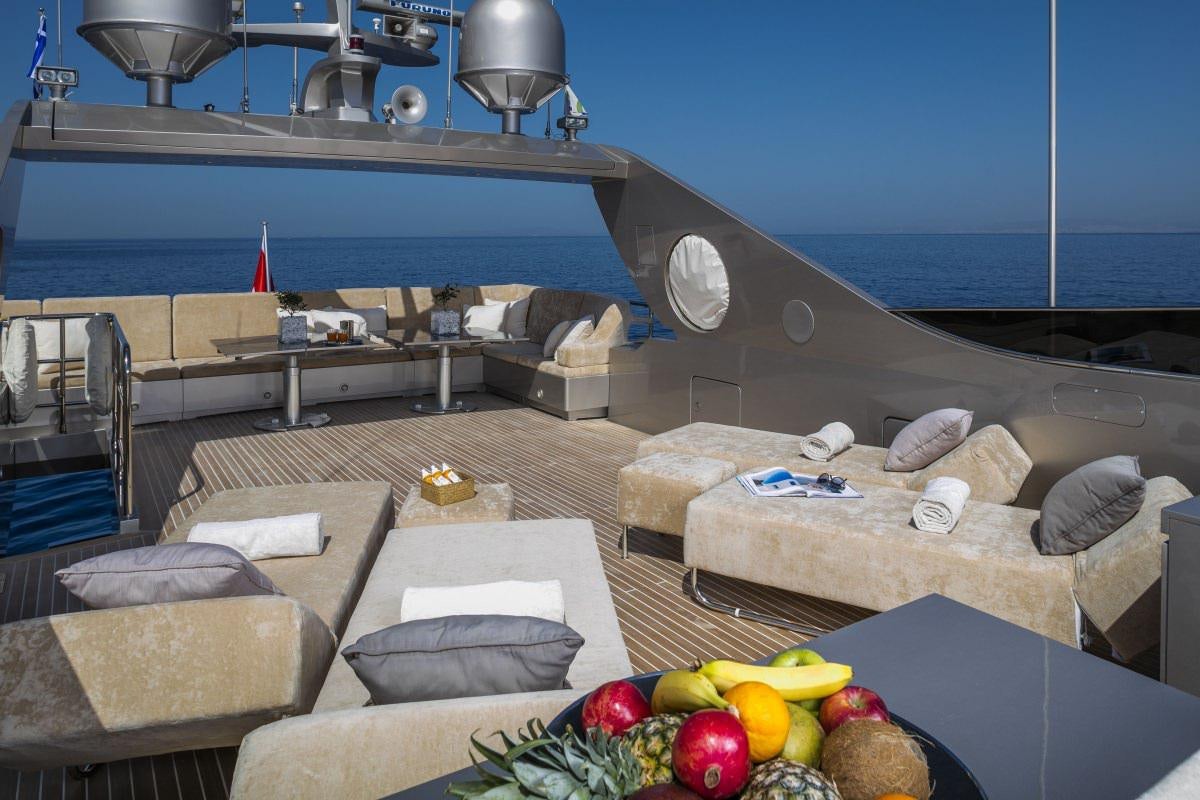 a room with a bed and a table with food on it aboard XANAX Yacht for Charter
