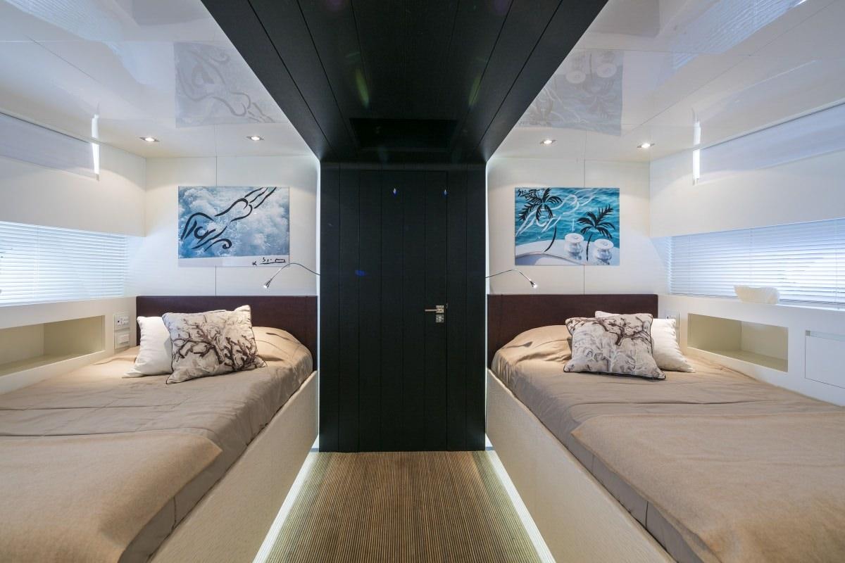 a room with a bed and a desk aboard XANAX Yacht for Charter