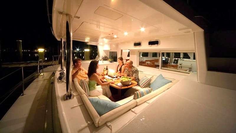 people sitting around a table aboard SASHA Yacht for Charter