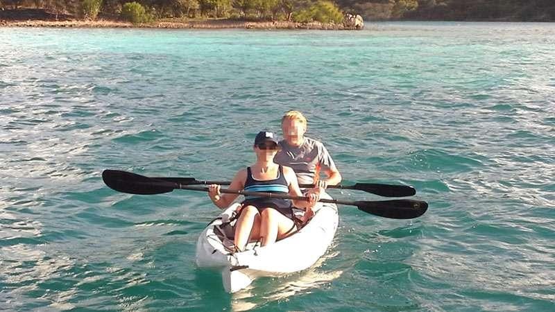 a man and woman in a canoe aboard SASHA Yacht for Charter