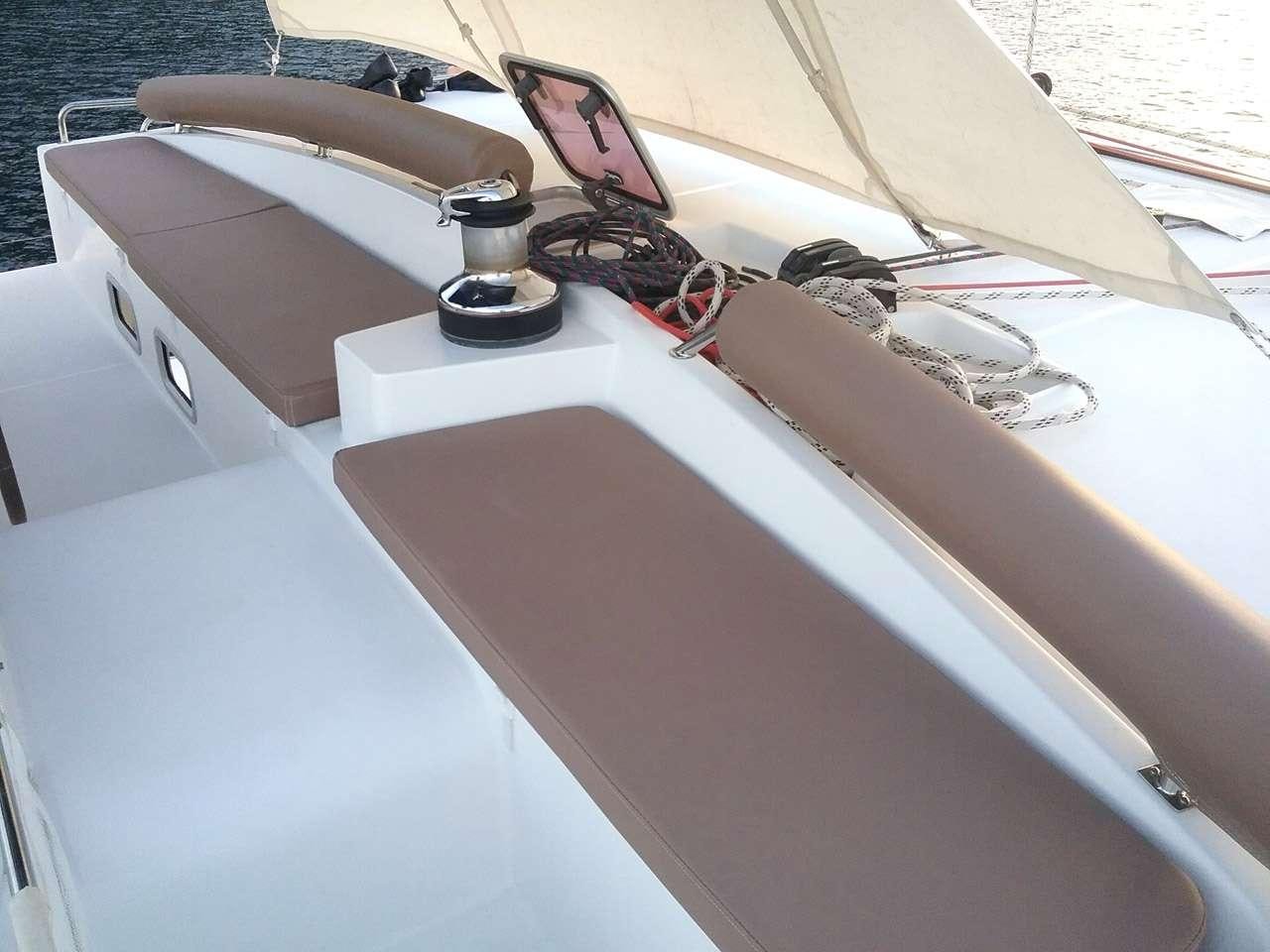 a white boat with a black and red sail aboard SASHA Yacht for Charter