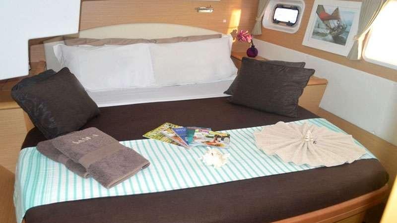 a bed with a tray of food on it aboard SASHA Yacht for Charter