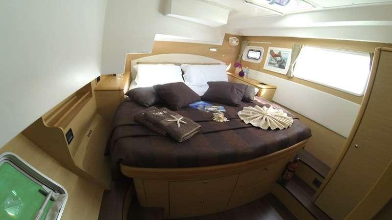 a bed with a brown bed spread aboard SASHA Yacht for Charter