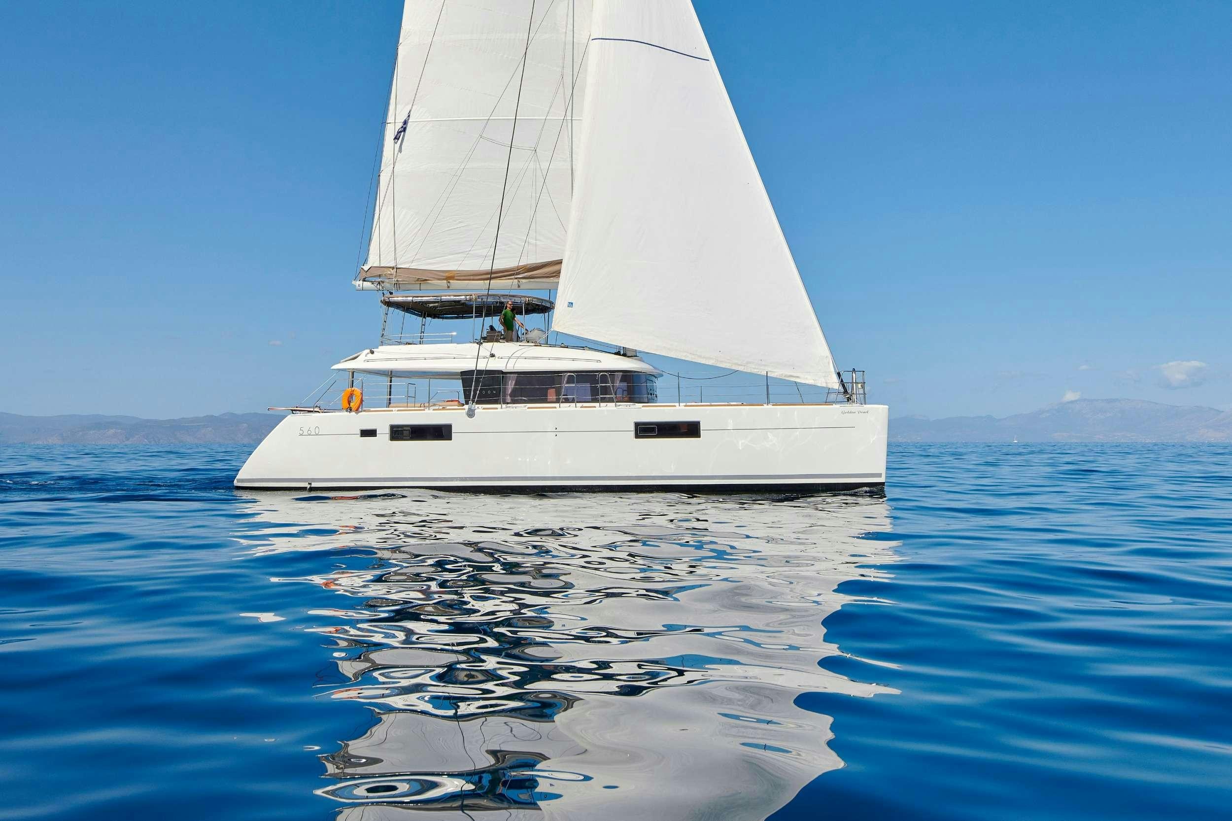 a white boat in the water aboard GOLDEN PEARL Yacht for Charter