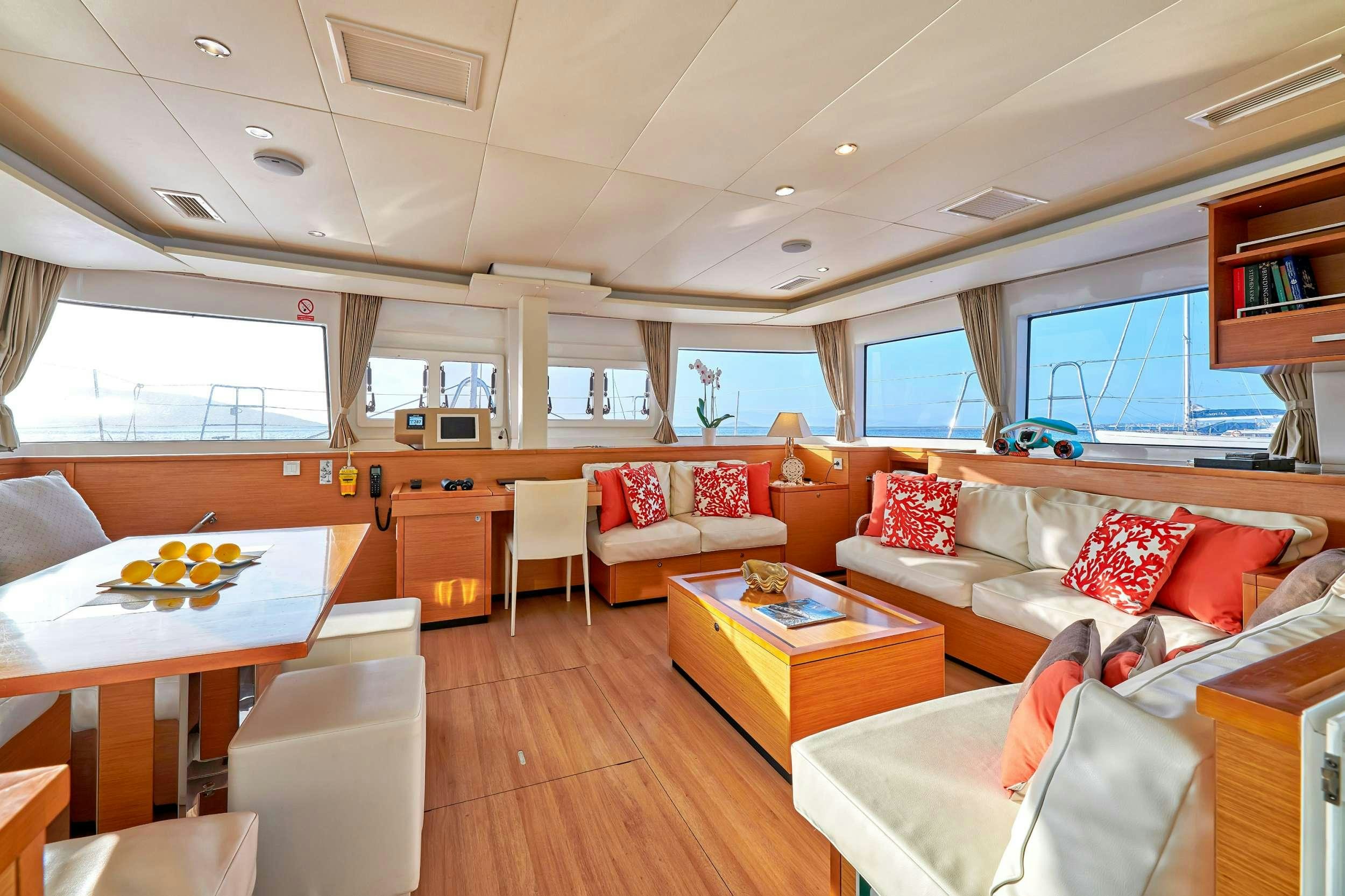 a living room with a couch and a table aboard GOLDEN PEARL Yacht for Charter