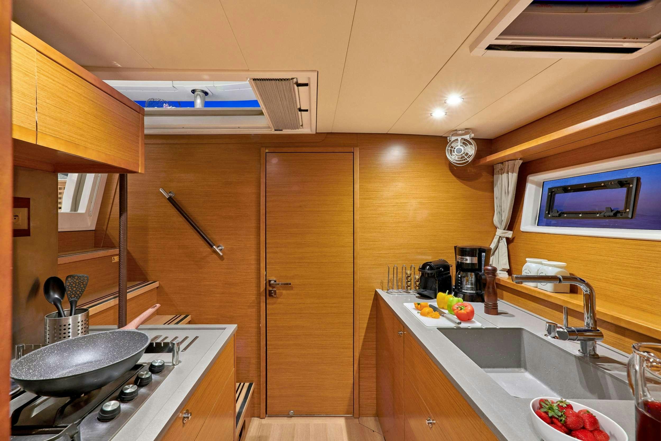 a kitchen with wooden cabinets aboard GOLDEN PEARL Yacht for Charter