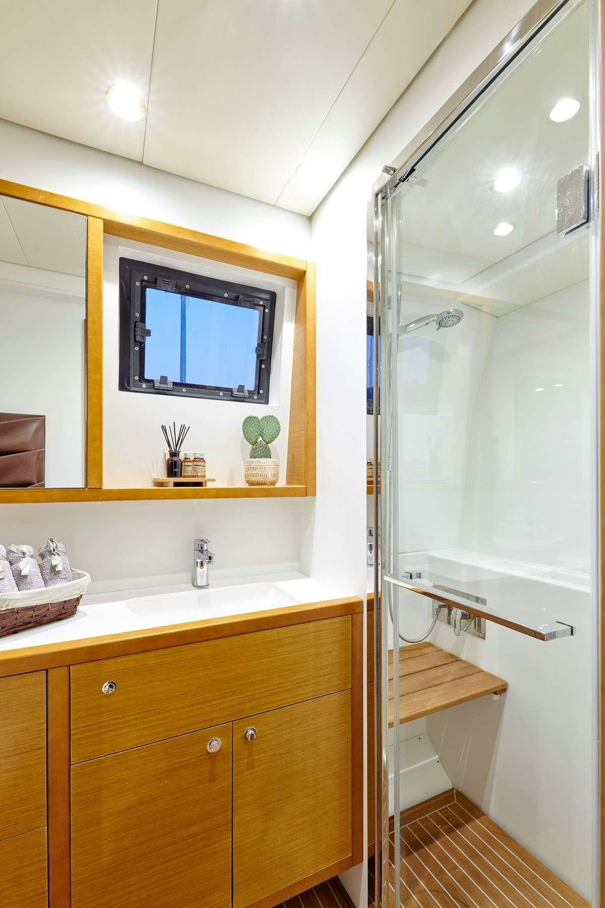 a bathroom with a glass shower aboard GOLDEN PEARL Yacht for Charter