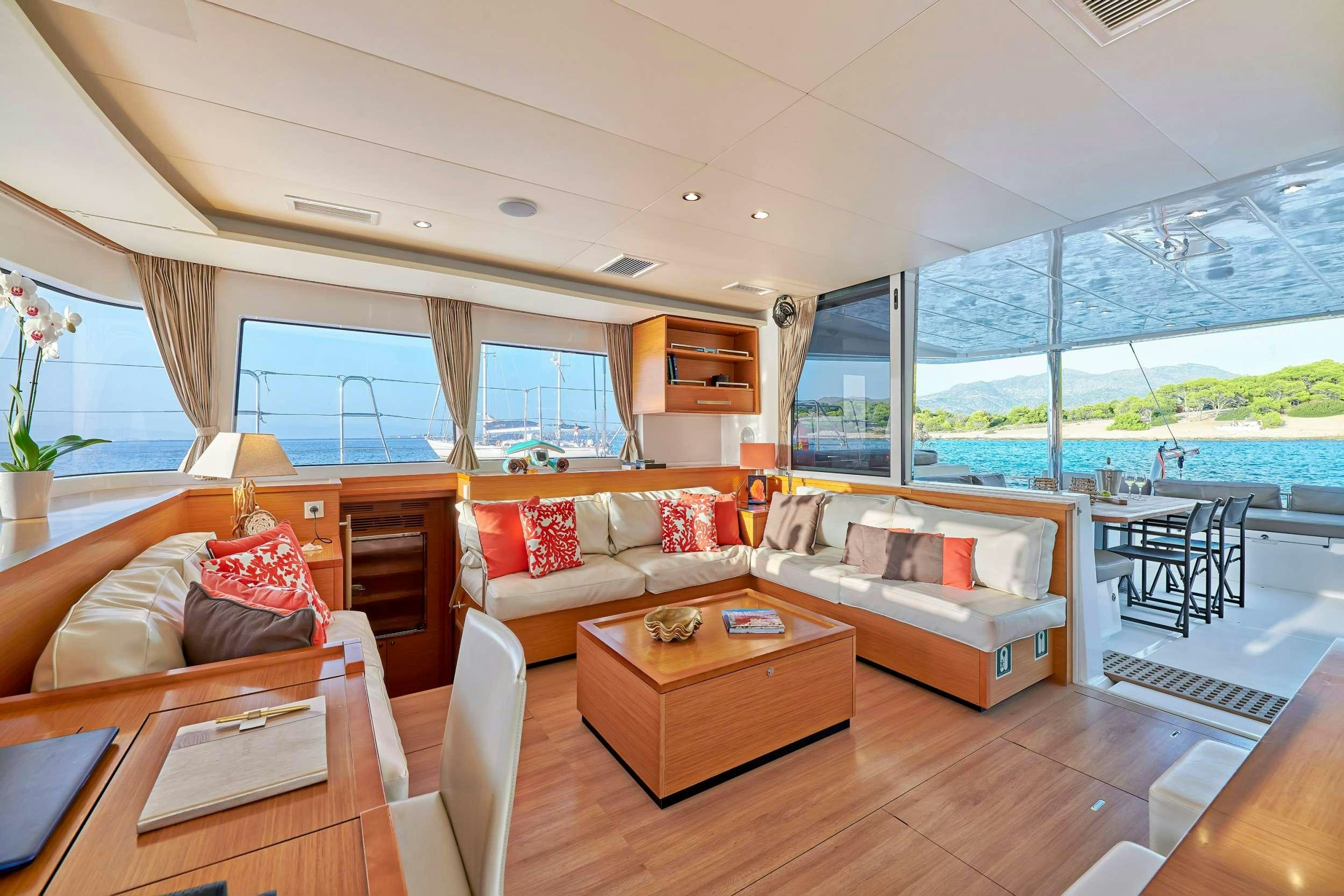 a living room with a large window aboard GOLDEN PEARL Yacht for Charter