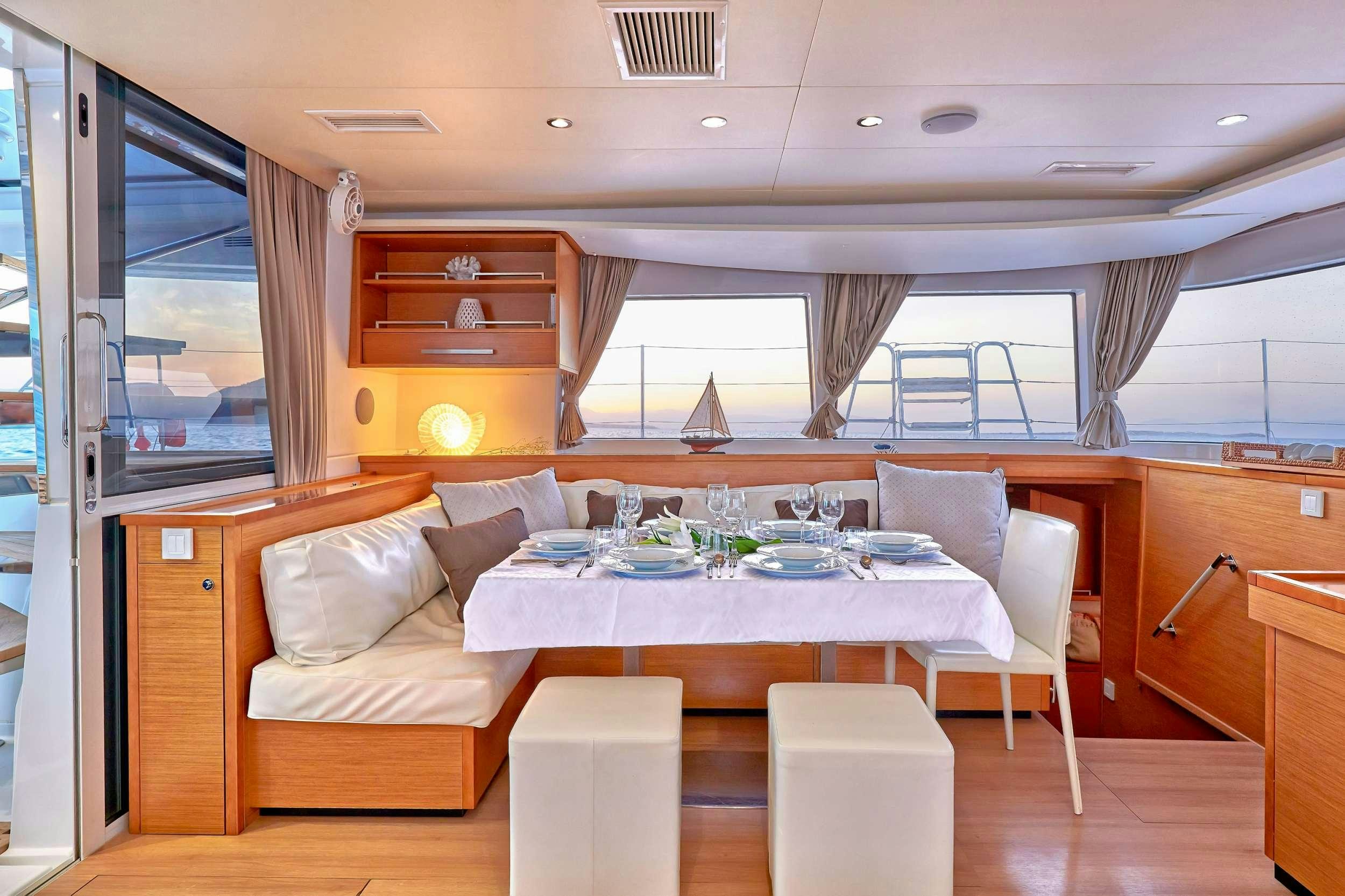 a room with a table and chairs aboard GOLDEN PEARL Yacht for Charter