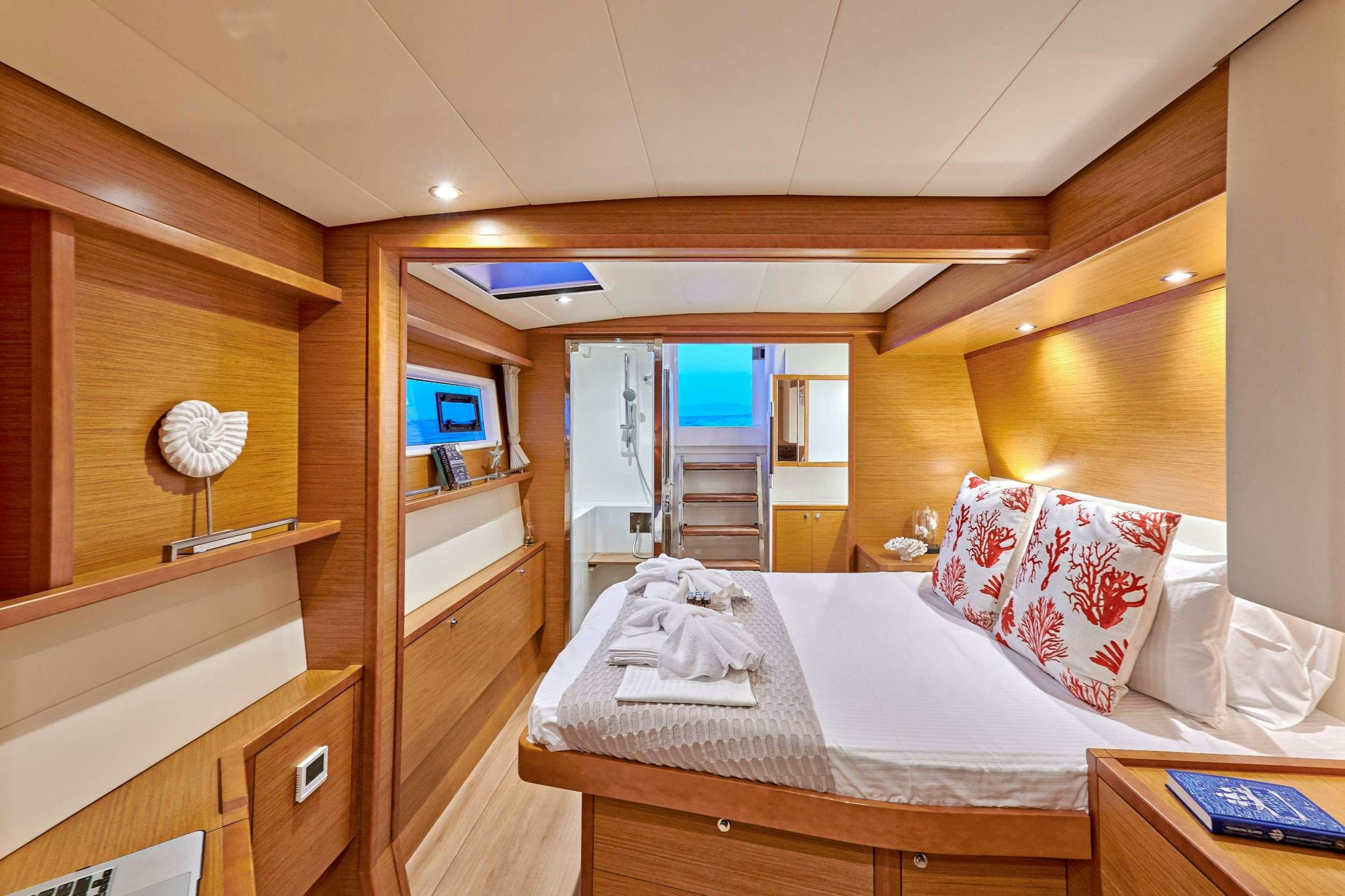 a bedroom with a bed and a desk aboard GOLDEN PEARL Yacht for Charter