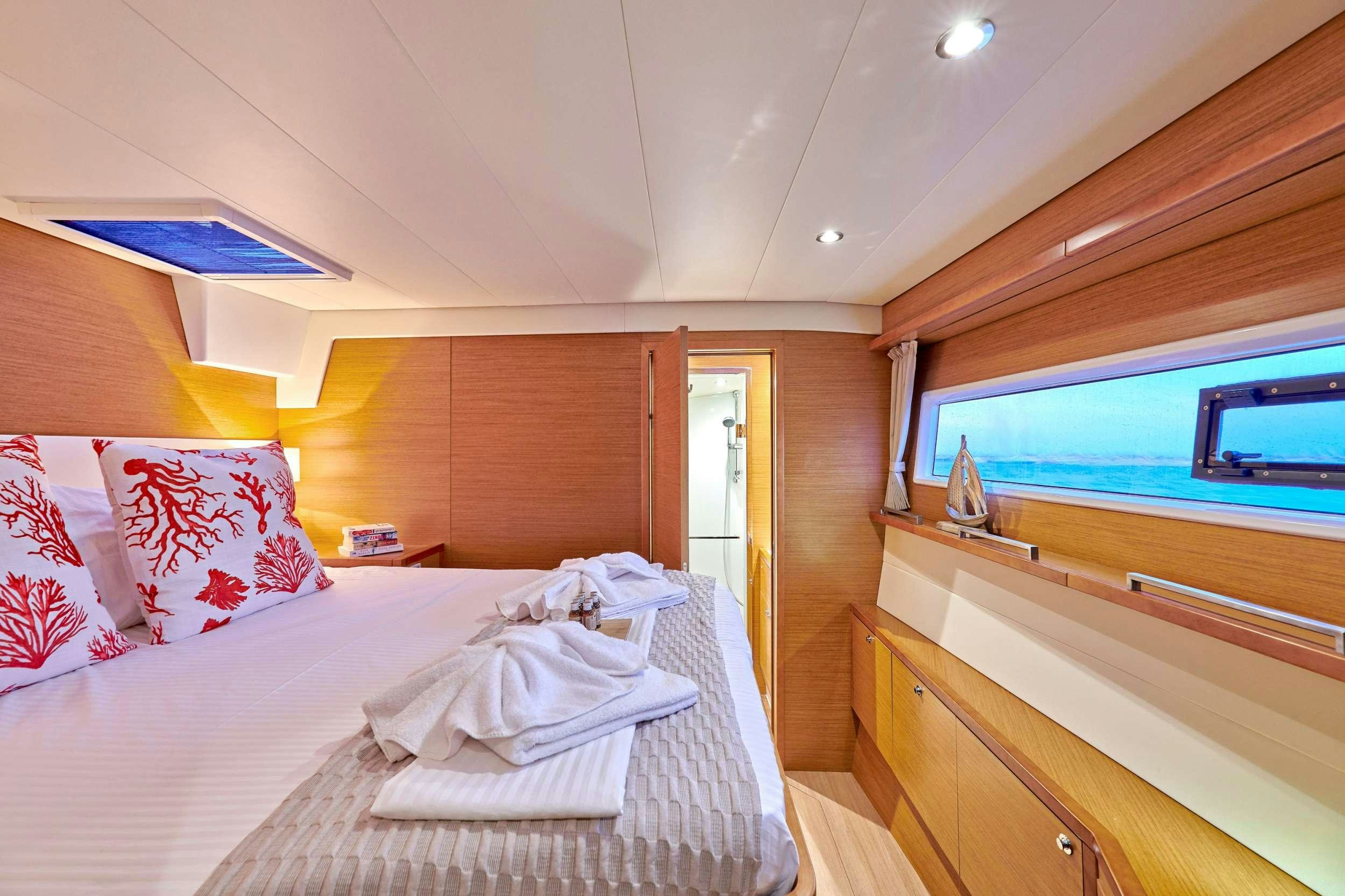 a room with a bed and a window aboard GOLDEN PEARL Yacht for Charter