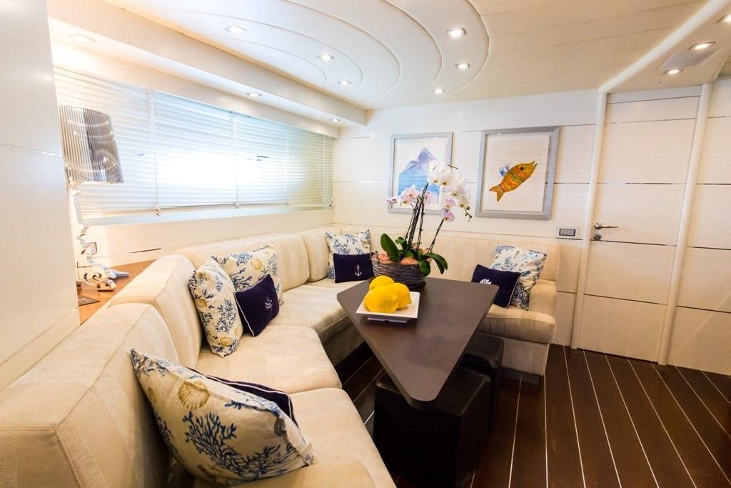 a living room with a couch and a table aboard CINQUE Yacht for Charter