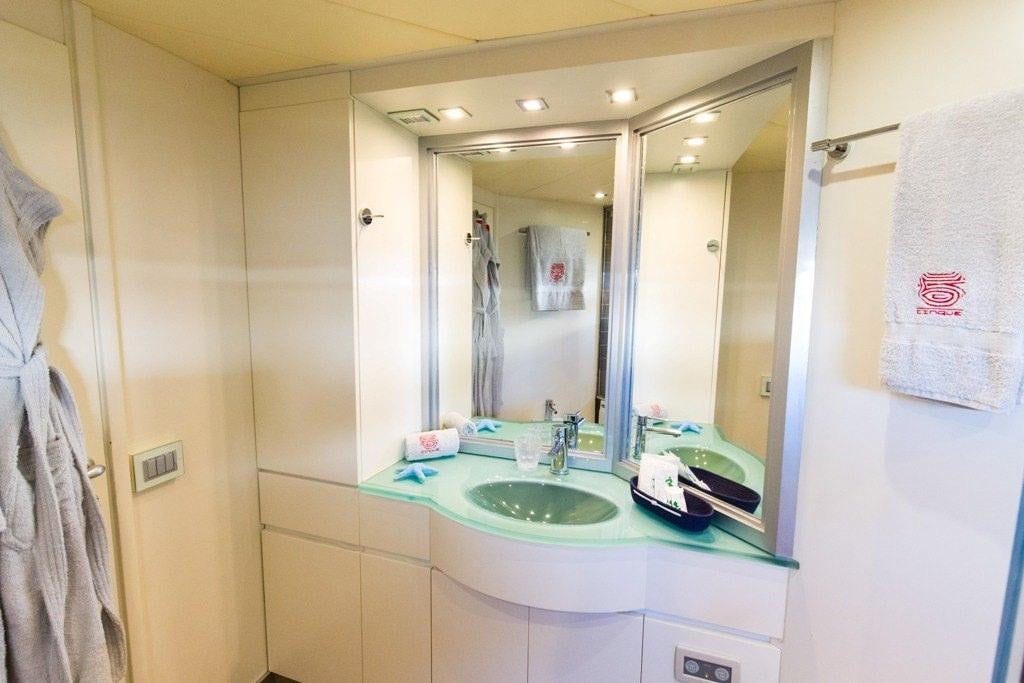 a bathroom with a large mirror aboard CINQUE Yacht for Charter