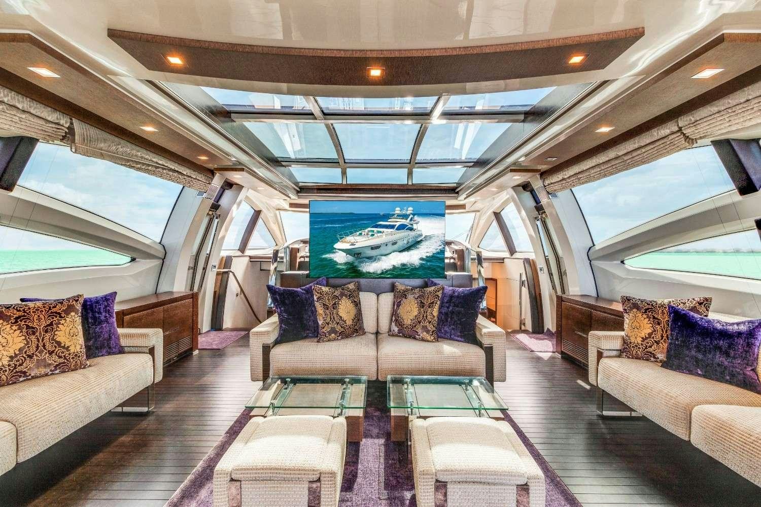 a large living room with a large pool table and couches aboard Scarlet Yacht for Charter