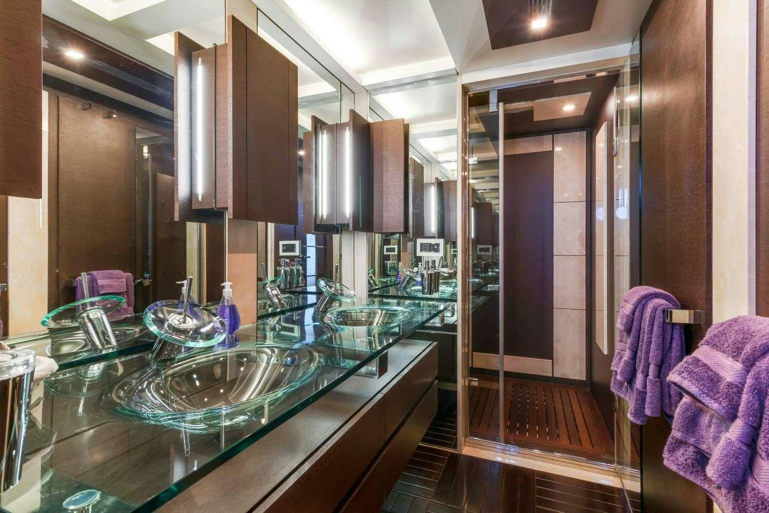 a bathroom with a countertop sink and a mirror aboard Scarlet Yacht for Charter