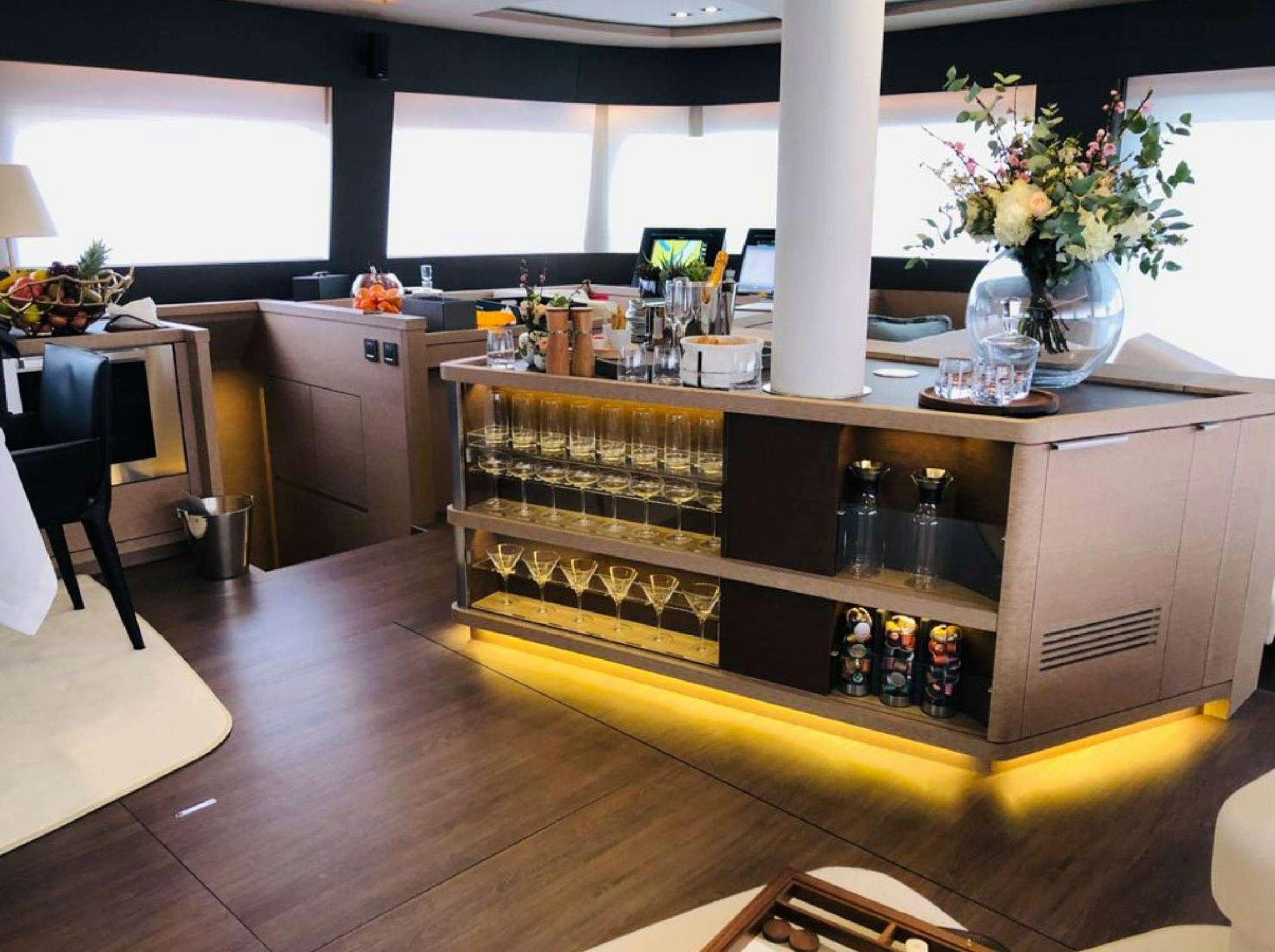 a bar with a lot of bottles on it aboard LA GATTA Yacht for Charter