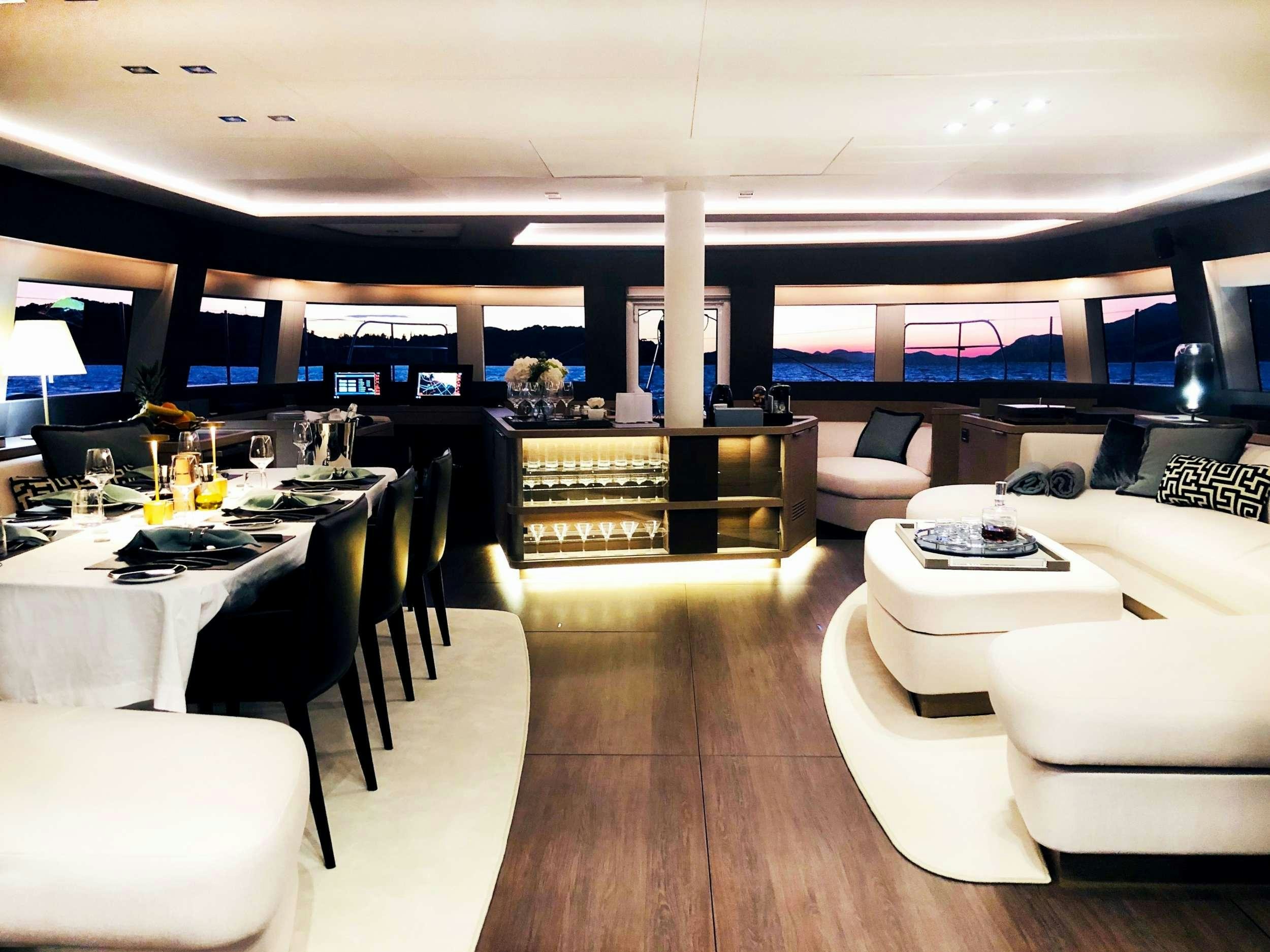 a room with a table and chairs aboard LA GATTA Yacht for Charter