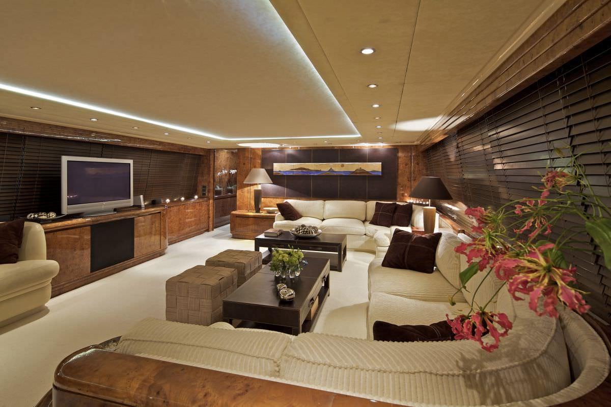 a living room with a large screen aboard OBSESION 120 Yacht for Charter