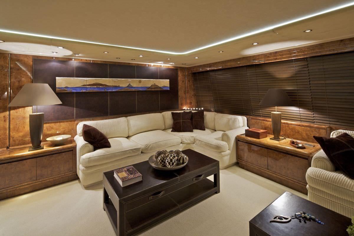 a living room with a couch and a coffee table aboard OBSESION 120 Yacht for Charter