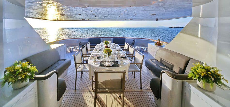 a room with a table and chairs aboard OBSESION 120 Yacht for Charter