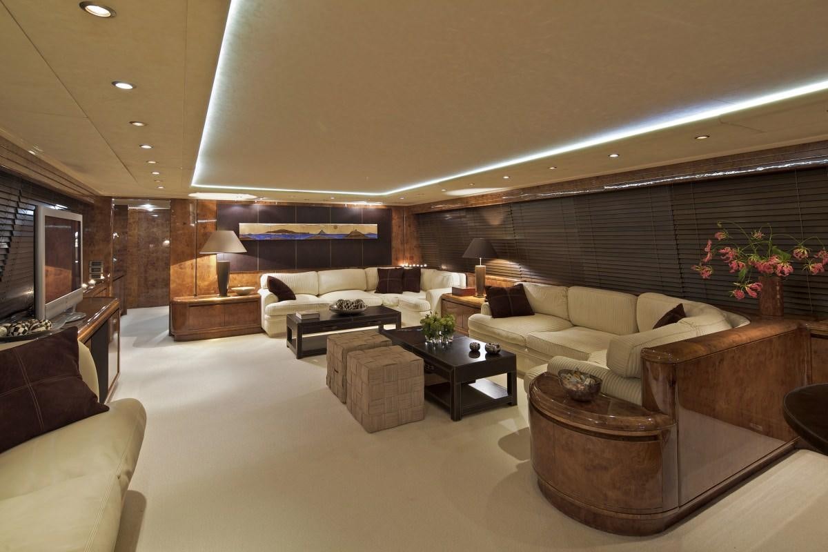 a living room with a large couch aboard OBSESION 120 Yacht for Charter
