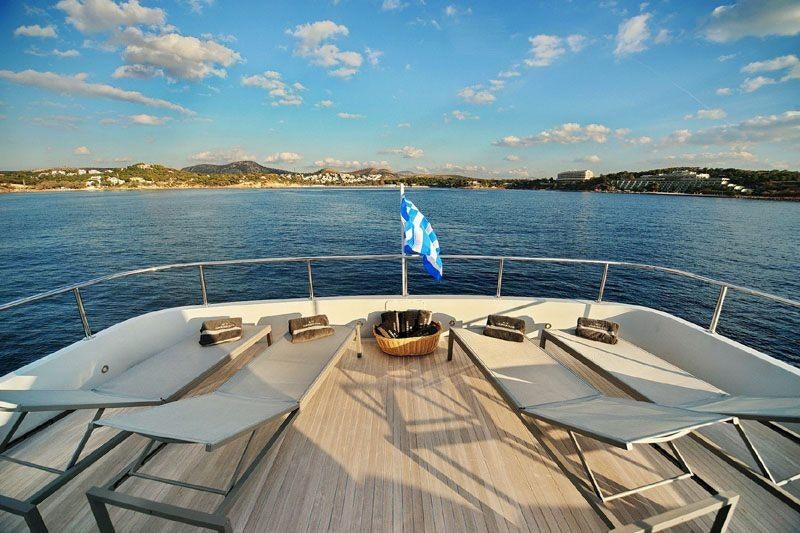 a boat on a dock with a flag on it aboard OBSESION 120 Yacht for Charter
