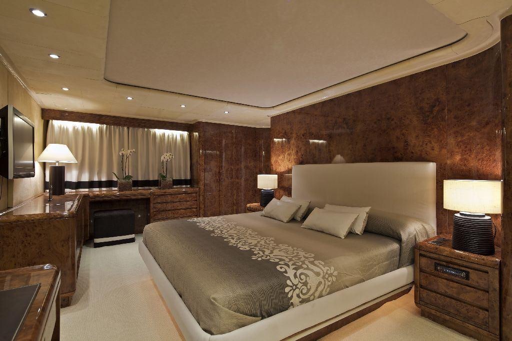 a large bedroom with a large bed aboard OBSESION 120 Yacht for Charter