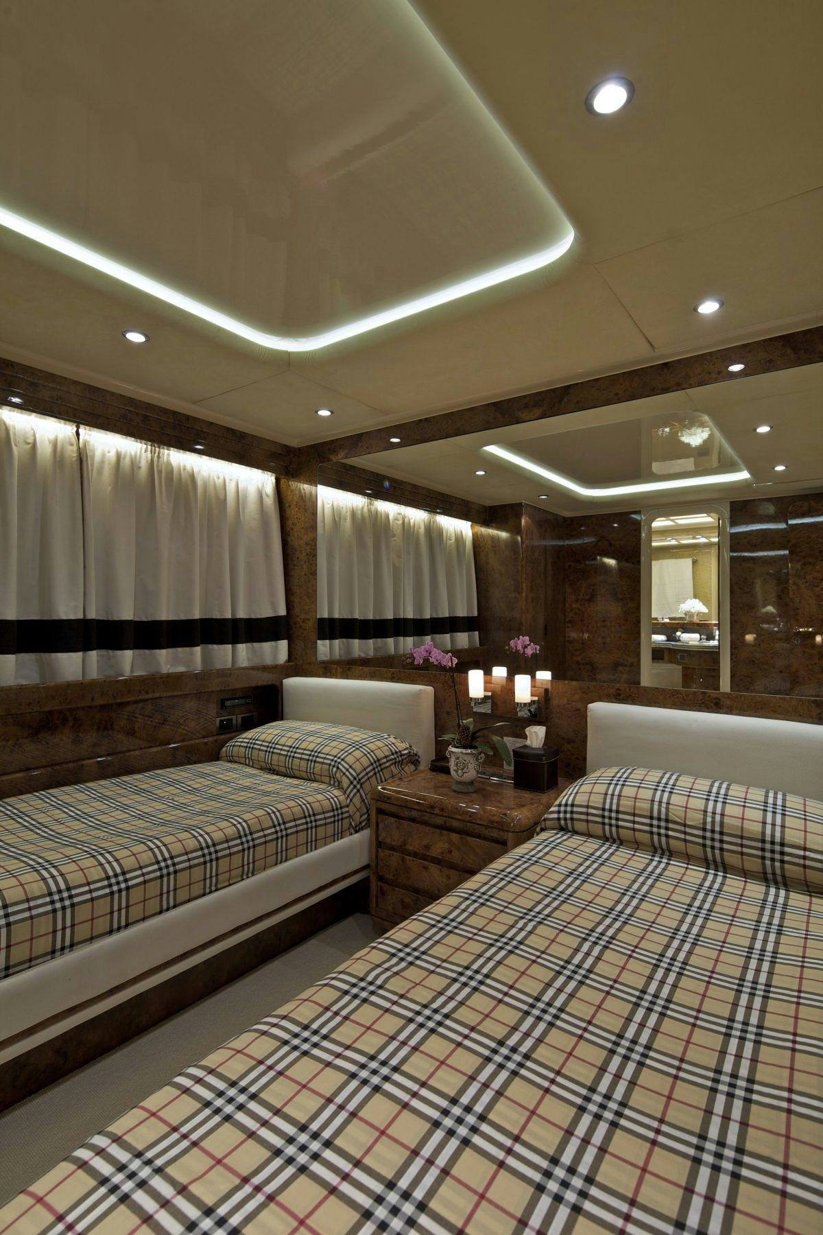 a couple of beds in a hotel room aboard OBSESION 120 Yacht for Charter