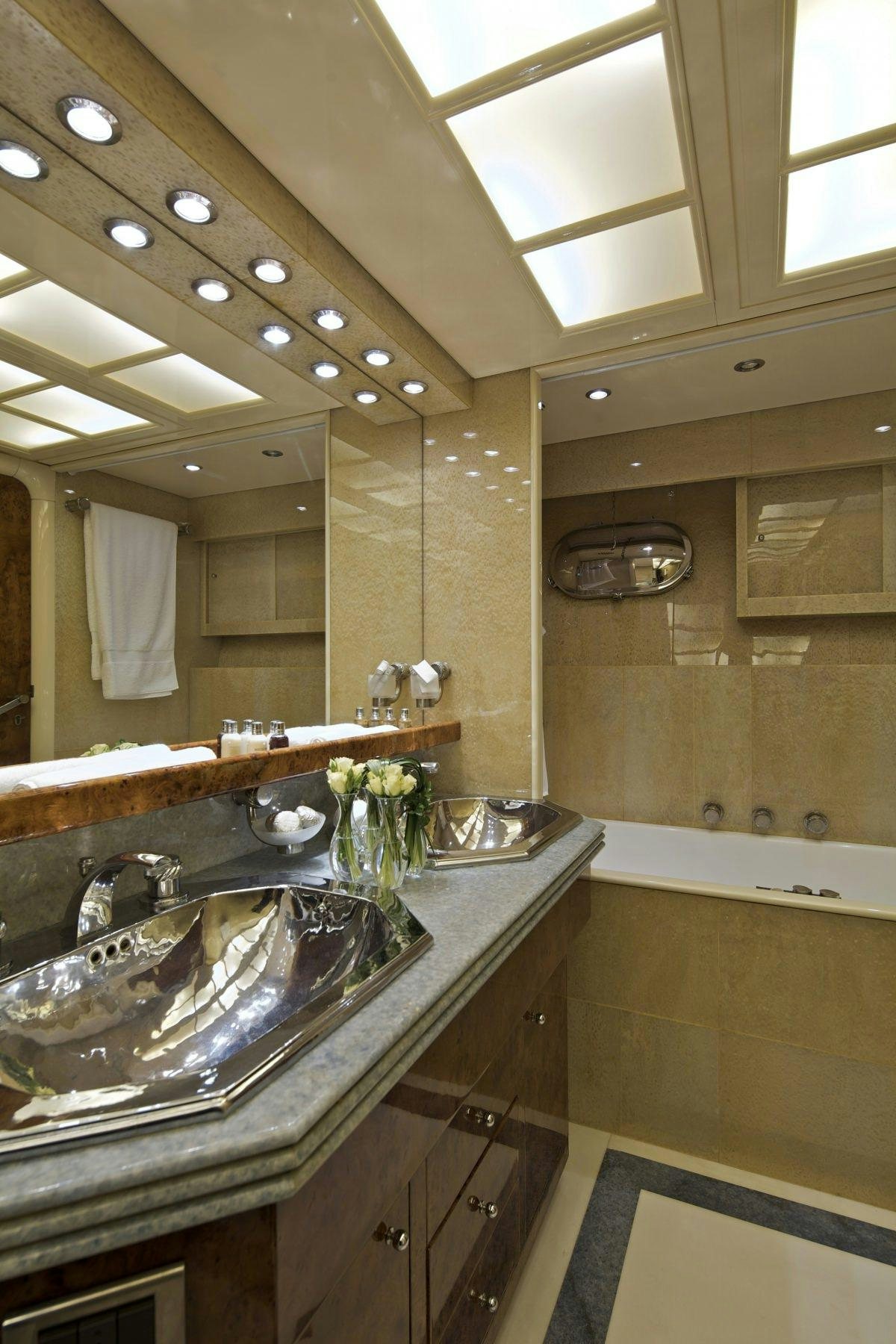 a bathroom with a sink and a large mirror aboard OBSESION 120 Yacht for Charter