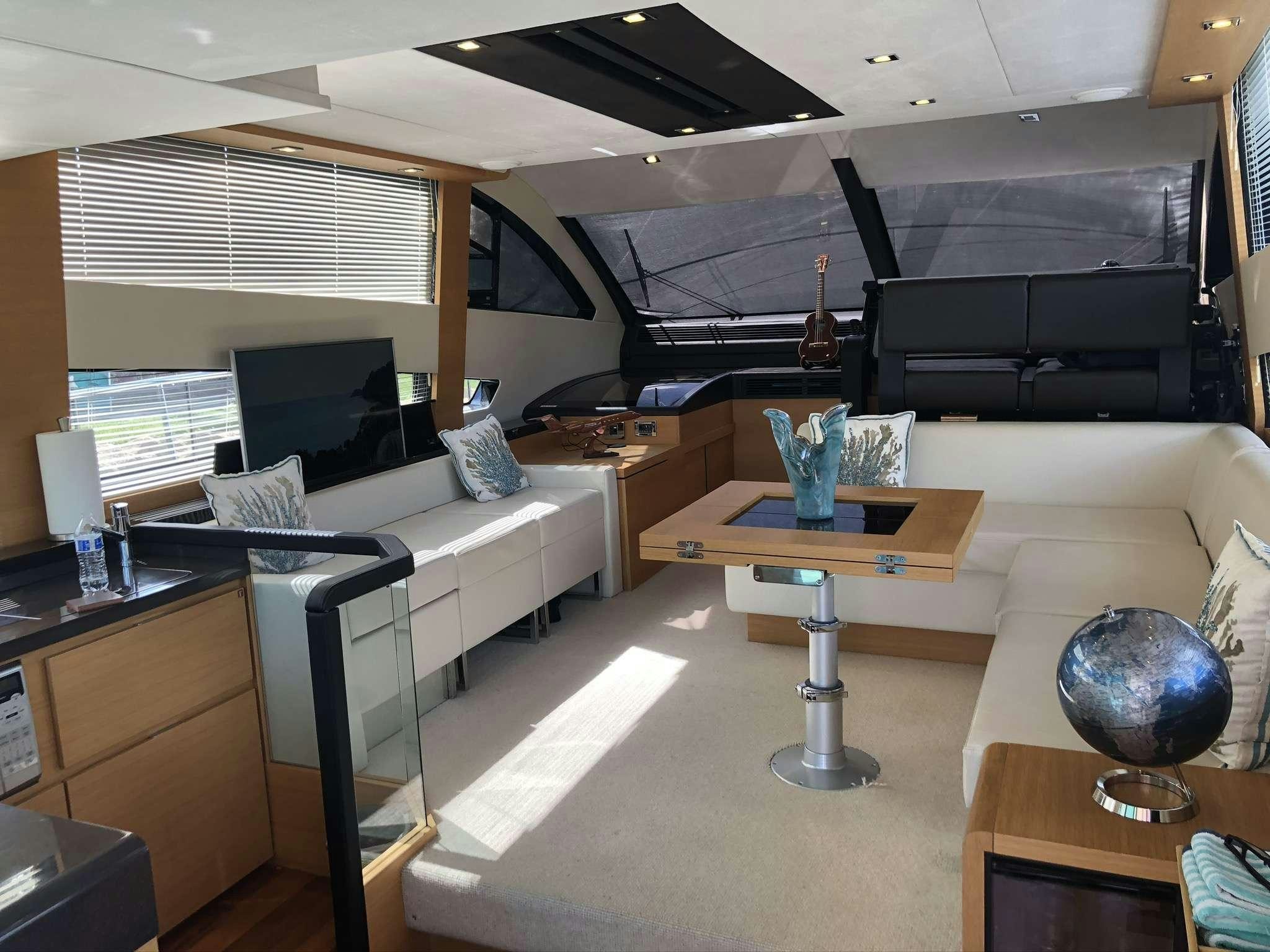 a room with a couch and a table aboard Synergy Yacht for Charter