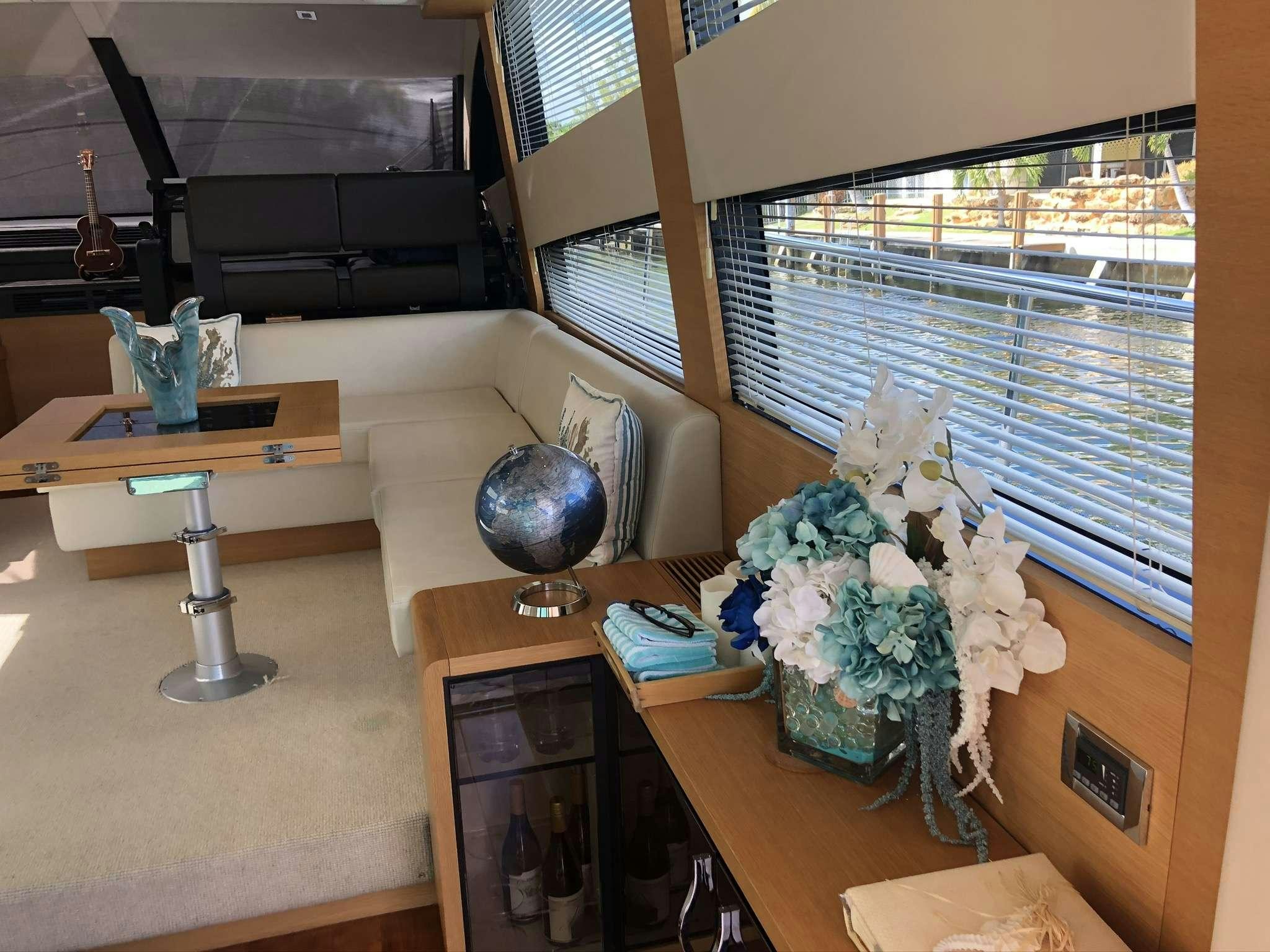 a room with a table and a vase with flowers on it aboard Synergy Yacht for Charter