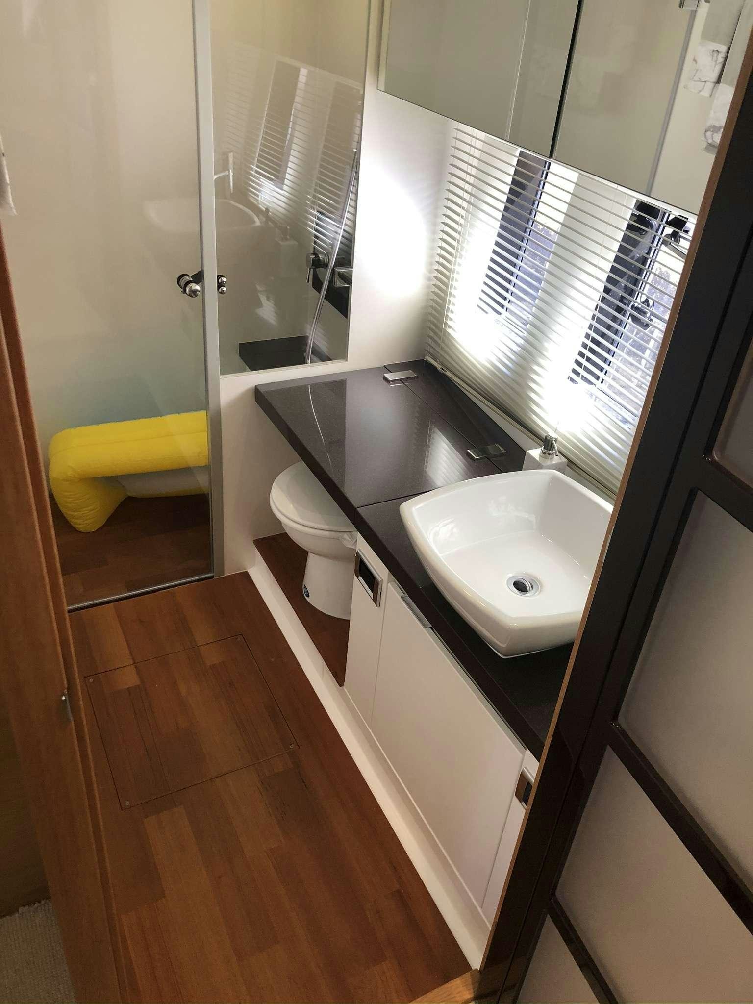 a bathroom with a sink and a mirror aboard Synergy Yacht for Charter