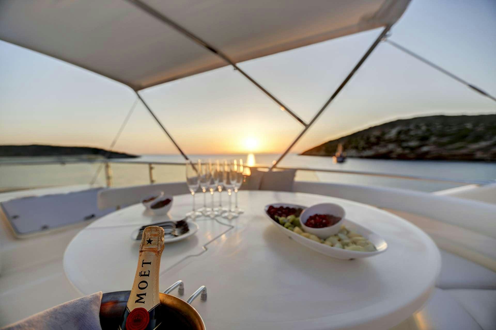a table with a guitar and a bowl of fruit on it aboard ALSIUM Yacht for Charter
