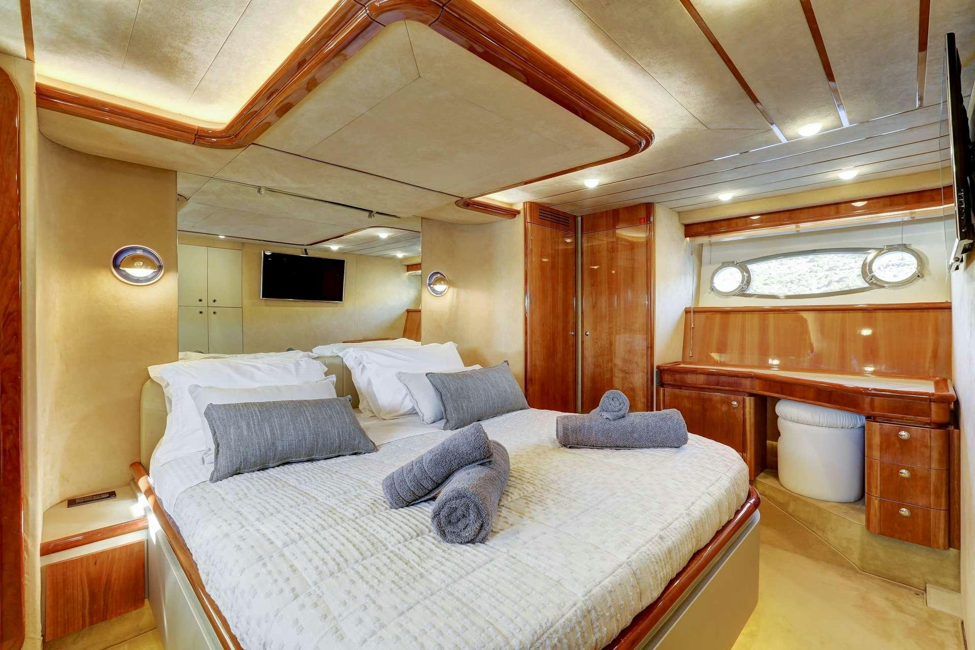 a bed with a white sheet aboard ALSIUM Yacht for Charter