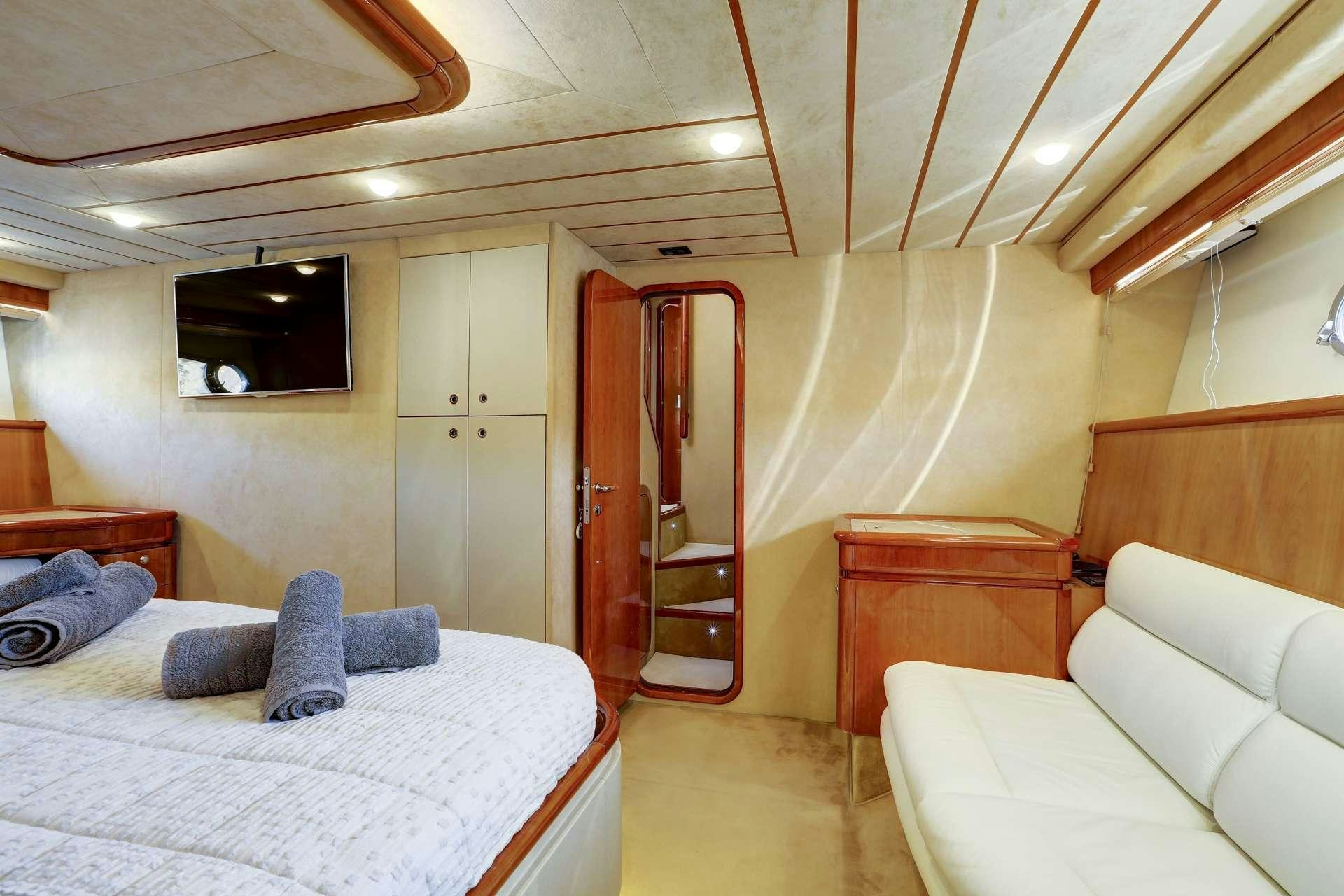 a room with a bed and a couch aboard ALSIUM Yacht for Charter