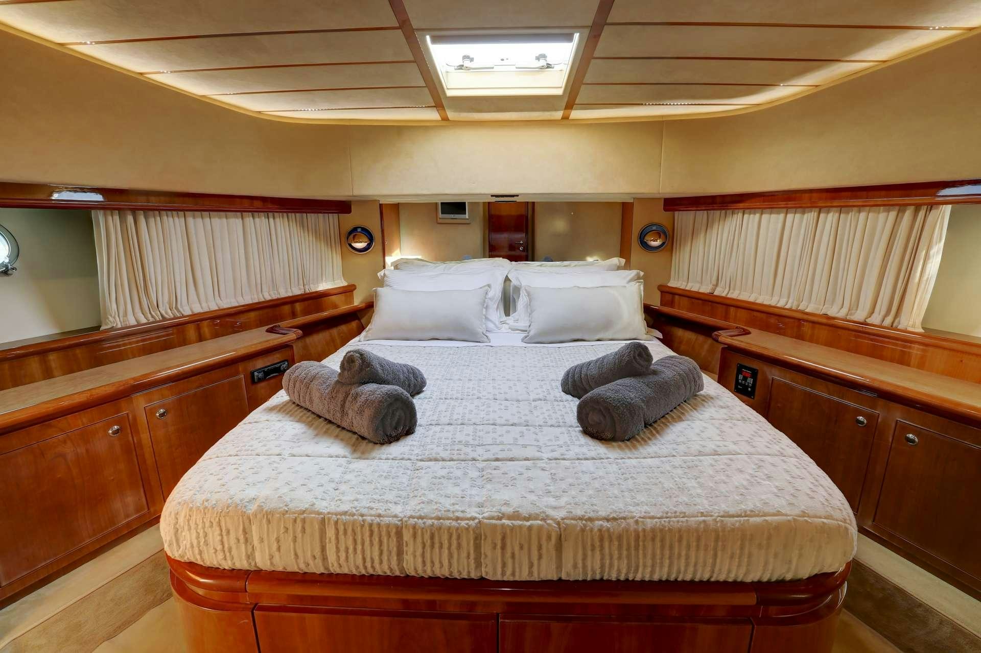 a bed with pillows on it aboard ALSIUM Yacht for Charter