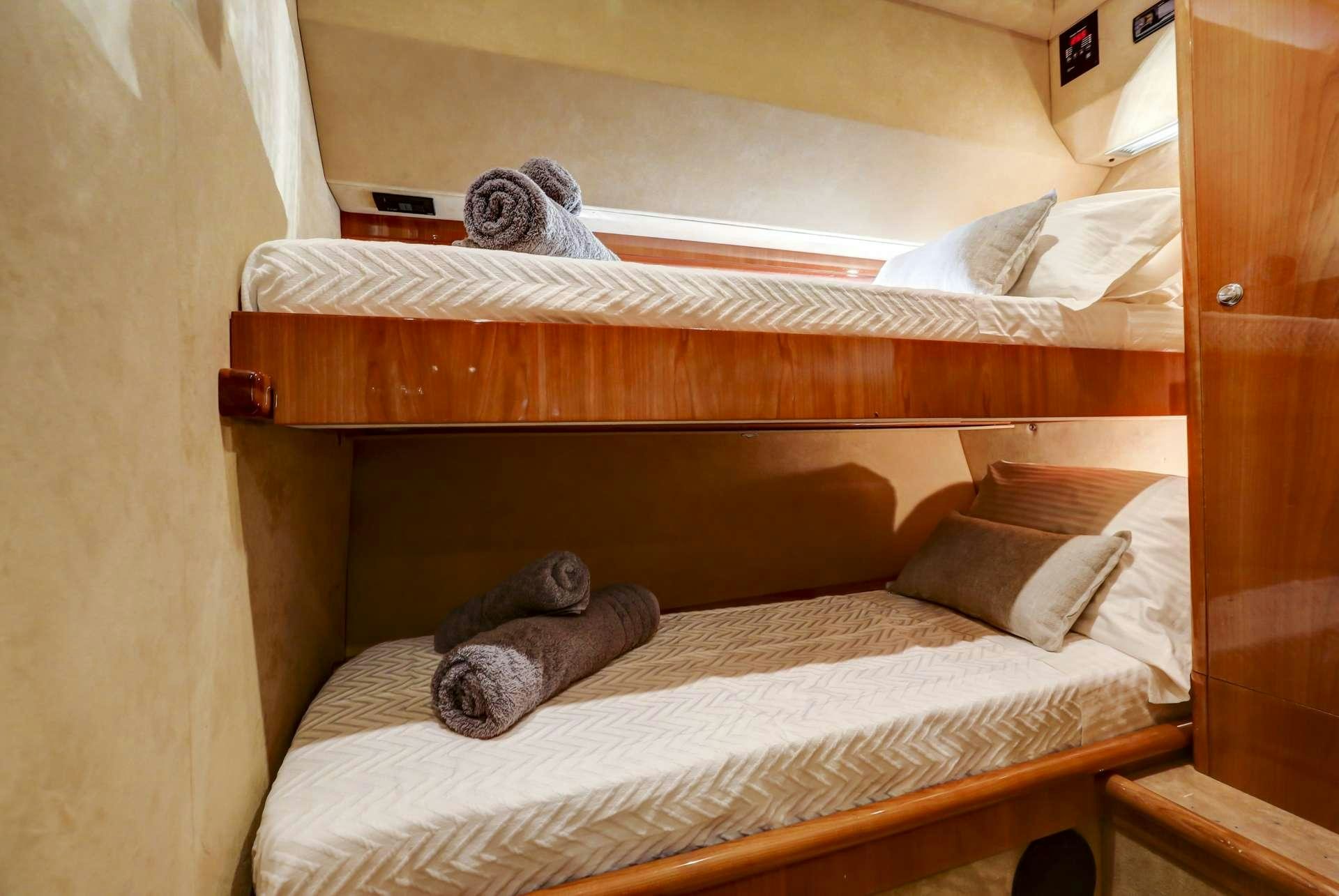 a bed with a couple of stuffed animals on it aboard ALSIUM Yacht for Charter