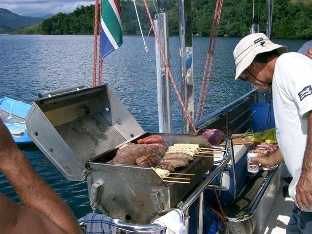 a man is preparing food on a boat aboard EXTASEA 2 Yacht for Charter
