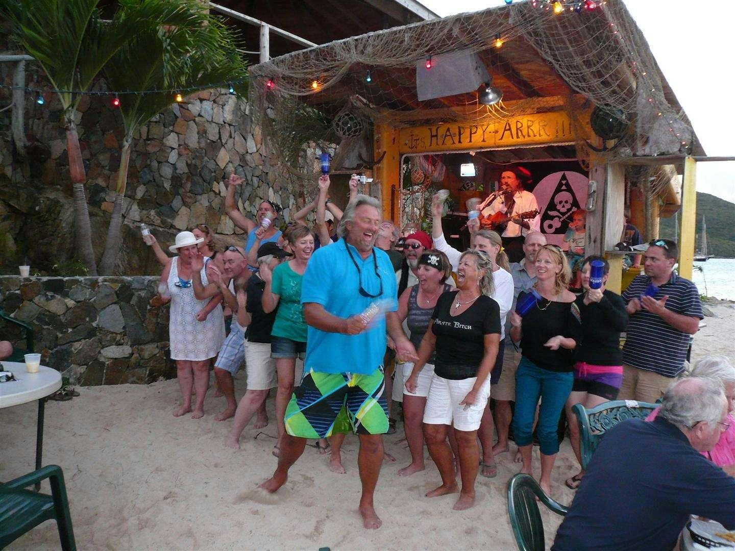 a group of people dancing in front of a building aboard EXTASEA 2 Yacht for Charter