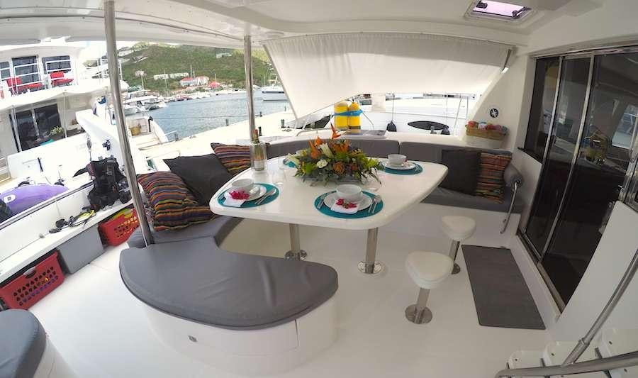 a table with plates and flowers on it aboard EXTASEA 2 Yacht for Charter