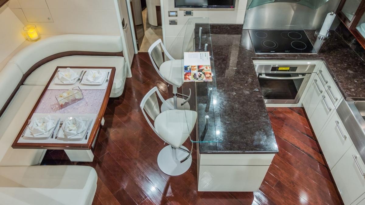 a kitchen with a table and a sink aboard CARPE DIEM Yacht for Charter