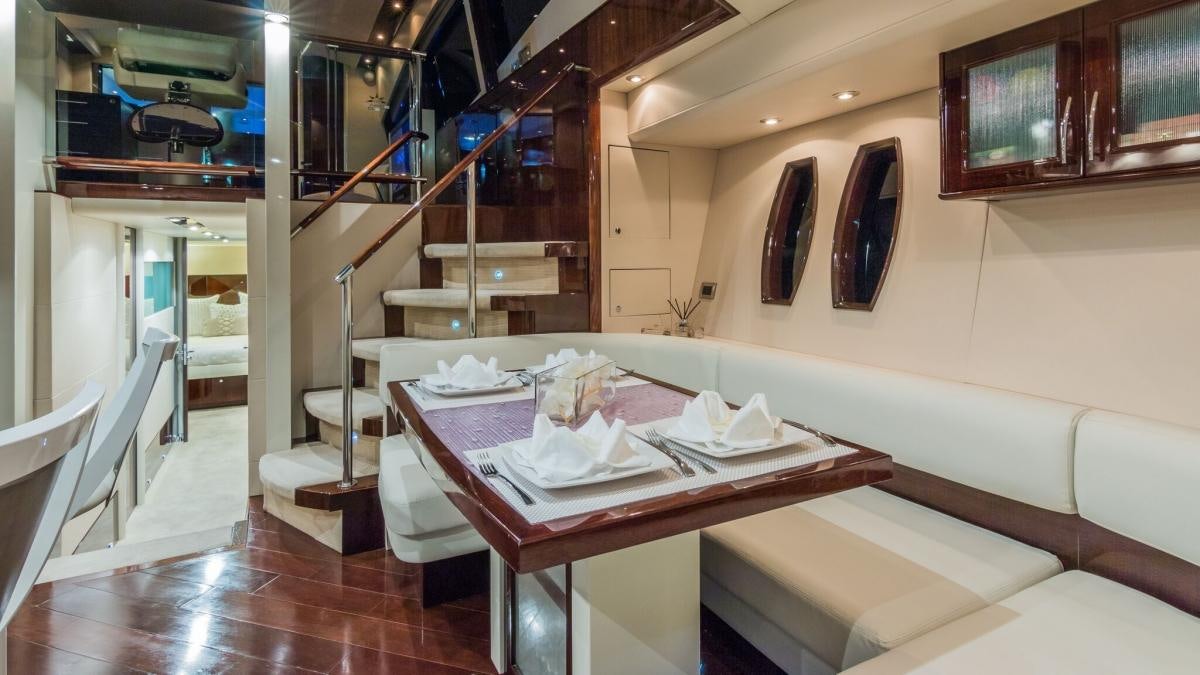 a room with a table and chairs aboard CARPE DIEM Yacht for Charter