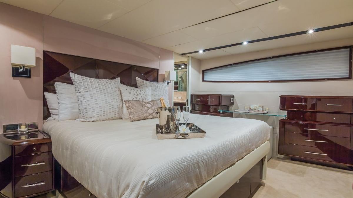 a bed with white sheets and pillows aboard CARPE DIEM Yacht for Charter