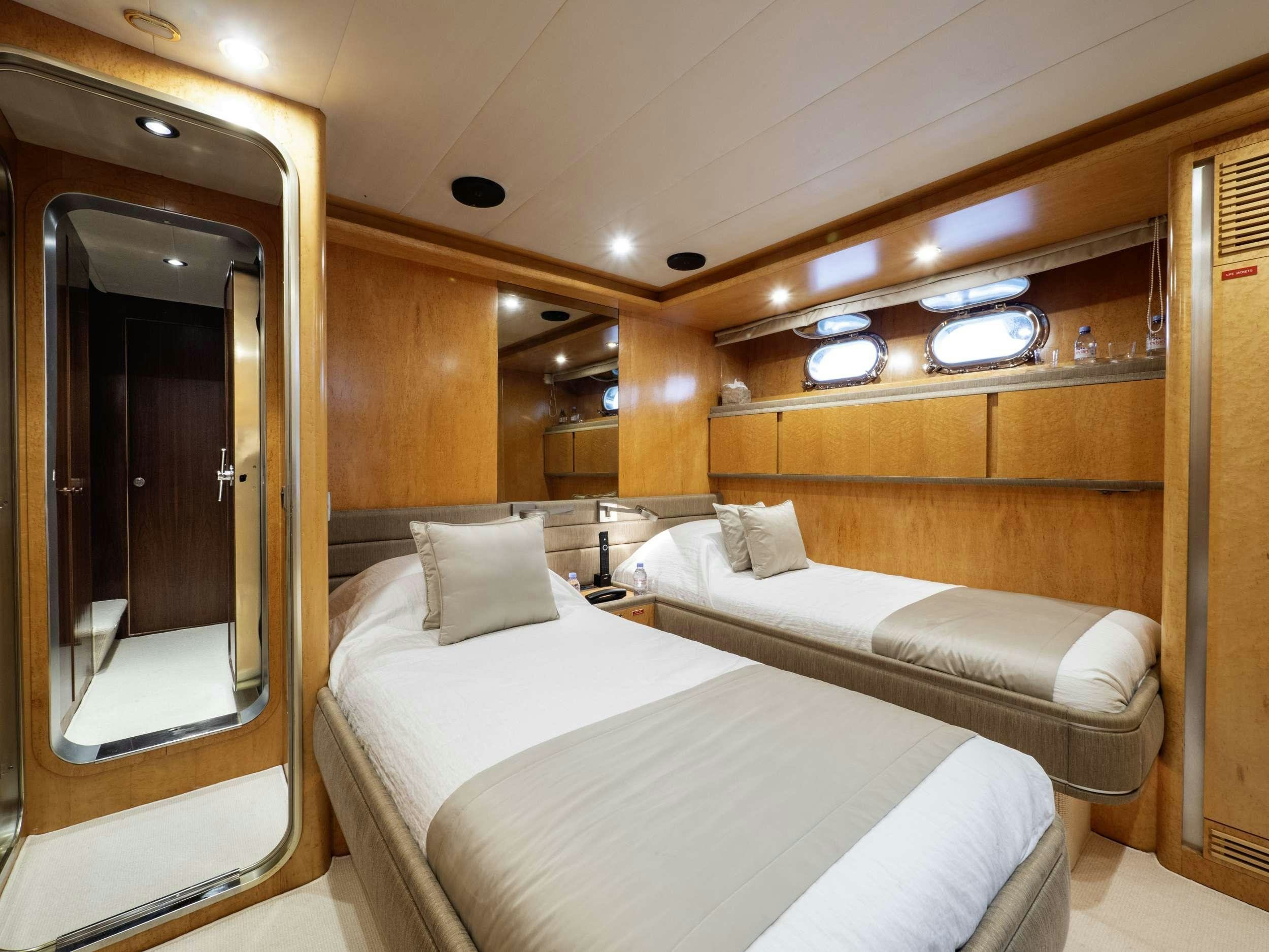 a room with two beds aboard SUNLINER X Yacht for Charter