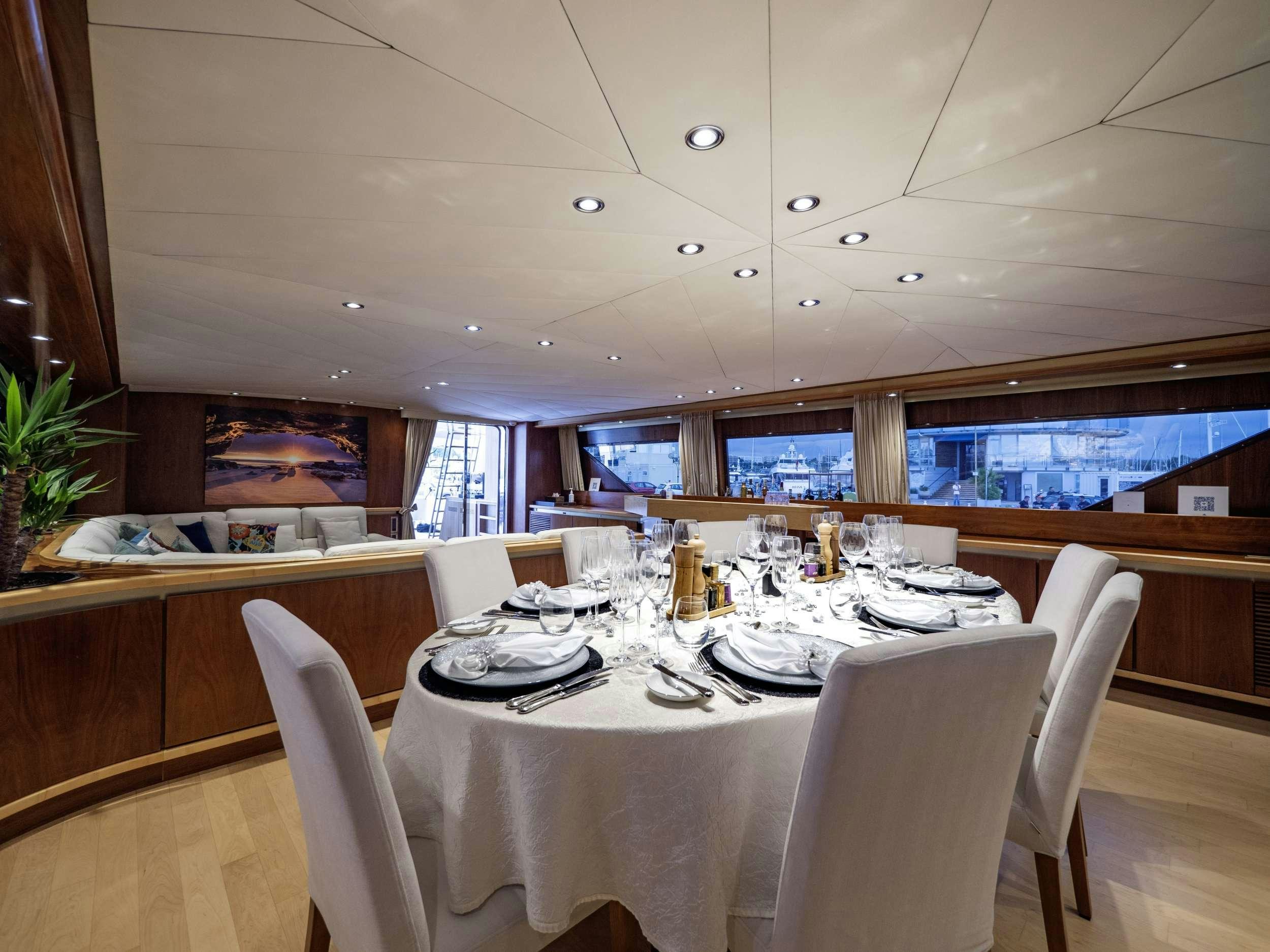 a room with tables and chairs aboard SUNLINER X Yacht for Charter