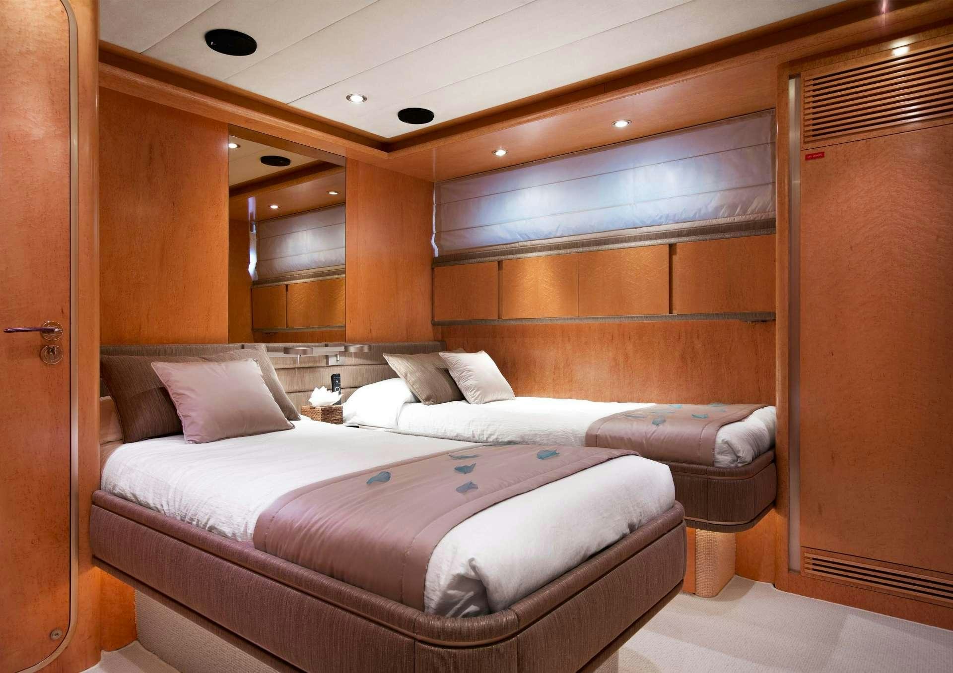 a room with a bed and a wood door aboard SUNLINER X Yacht for Charter