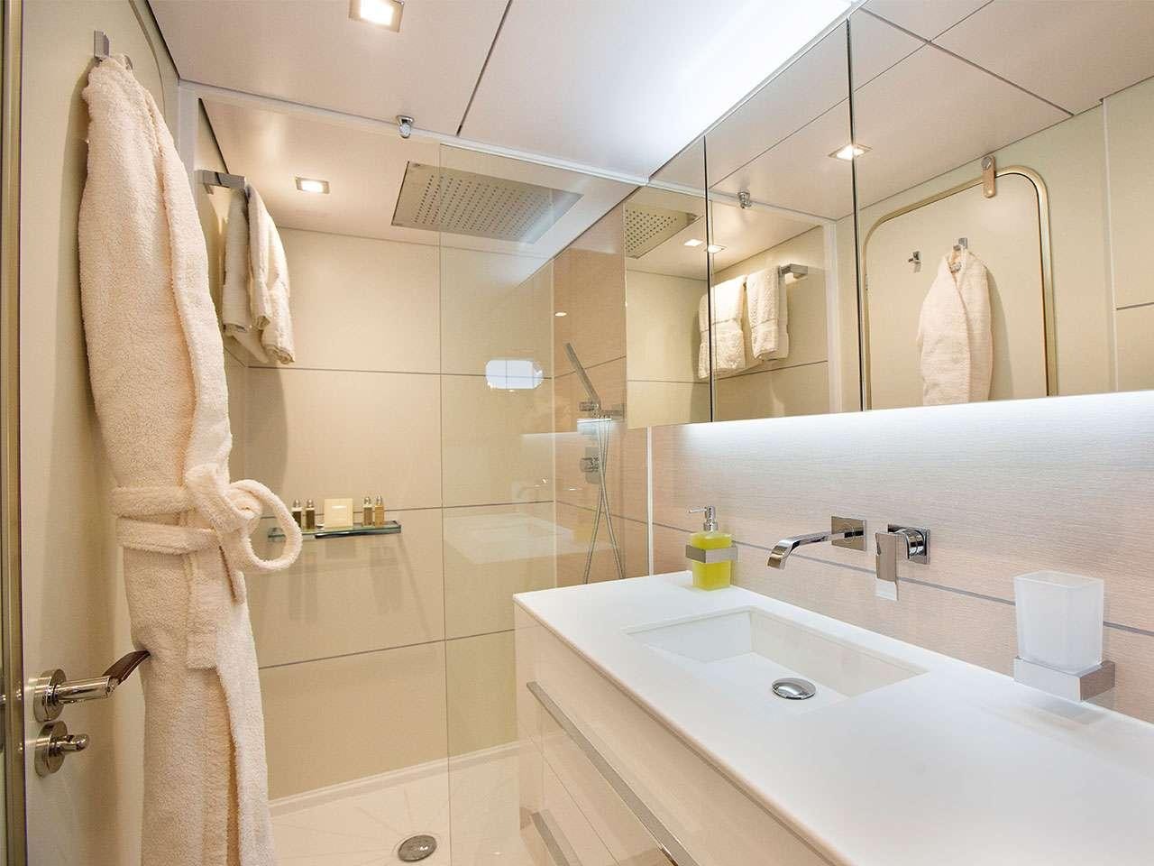 a bathroom with a sink and towels aboard SUNLINER X Yacht for Charter